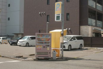 cars parked in front of brown building during daytime